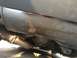1996 Ford Bronco - Close-up view of the undercarriage, focusing on the exhaust system and differential assembly.