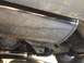 1996 Ford Bronco - Close-up view of the undercarriage of a vehicle, revealing mechanical parts and suspension system.