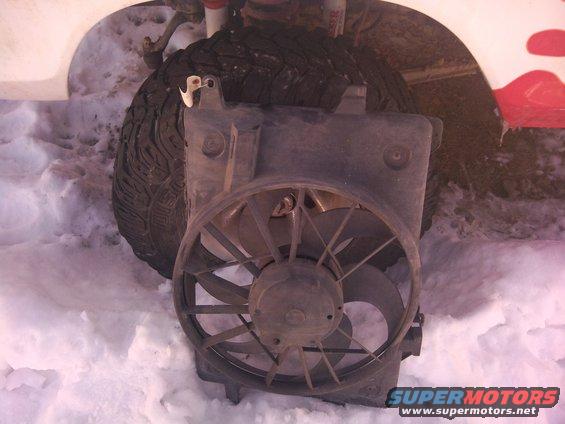 Electric fan assembly in front of a tire in the snow