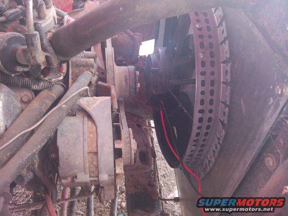 Engine bay view showing fan shroud, alternator, and hoses