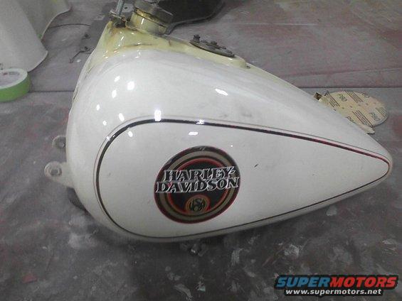 White Harley Davidson motorcycle gas tank with black and red pinstripes and circular logo