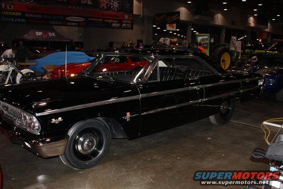 Black 1963 Ford Galaxie parked indoors with other vehicles visible