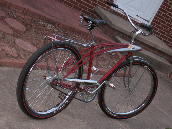 Red cruiser bicycle with chrome accents and Bontrager tires