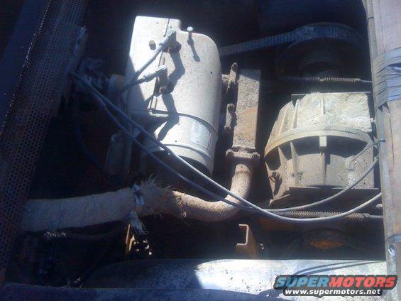 Engine bay with rusty components and hoses