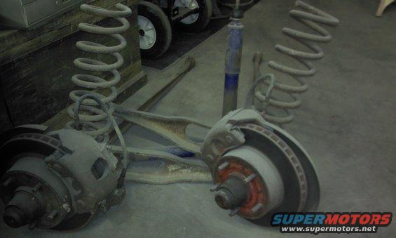 Two front suspension assemblies with coil springs and disc brakes, plus a shock absorber