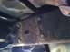 1996 Ford Bronco - Close-up view of a heavily rusted vehicle frame section with several bolts.