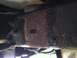 1996 Ford Bronco - Rusted frame section showing mounting points and bolts, likely from a vehicle's undercarriage.