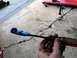 1996 Ford Bronco - A tool modified with tape to hold a nut is shown against a cracked concrete surface.