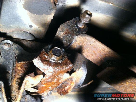 Rusted suspension part with bolt