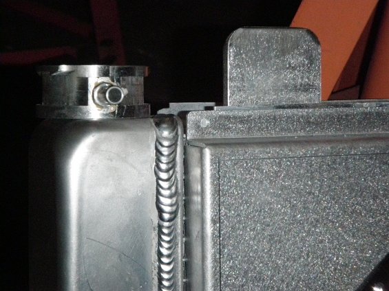 Aluminum radiator with a silver cap and visible welds