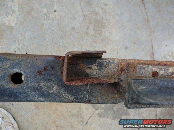 rusted metal frame section with a U-shaped bracket attached