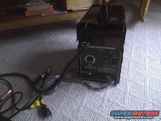 Black welding machine with controls and cables