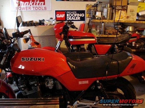 Red Suzuki GS1100E motorcycle side view, with another red motorcycle behind it