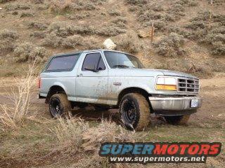Light blue 1996 Ford Bronco parked on dirt road