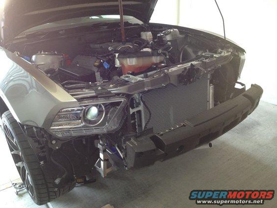 Gray 2010 Ford Mustang front end with hood open, bumper removed, showing engine and radiator