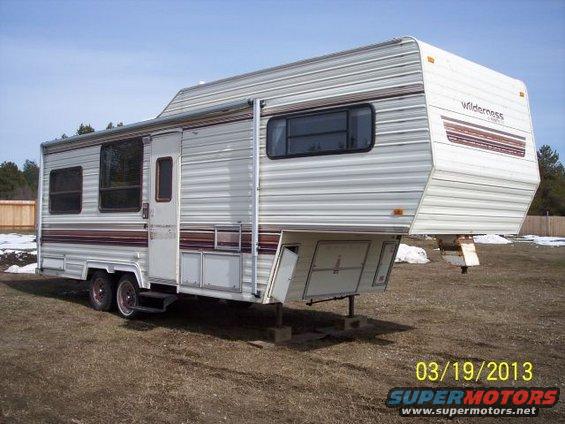 Fifth wheel camper with 'Wilderness' branding on the front