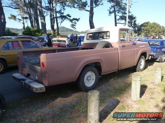 Brown and white 1957 Ford pickup truck, rear 3/4 view