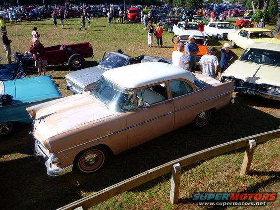 Pink two-door sedan with white roof, 3/4 front view