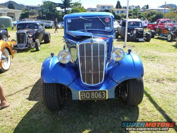 Blue hot rod with chrome grille and license plate BQ 8063