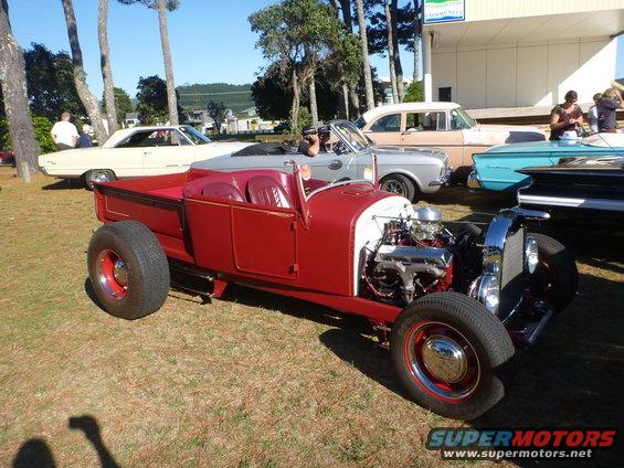Red hot rod pickup truck with exposed engine and red interior