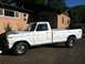 1977 Ford F-350 - This white 1977 Ford F-350 pickup truck is shown from the side, parked in front of a house.