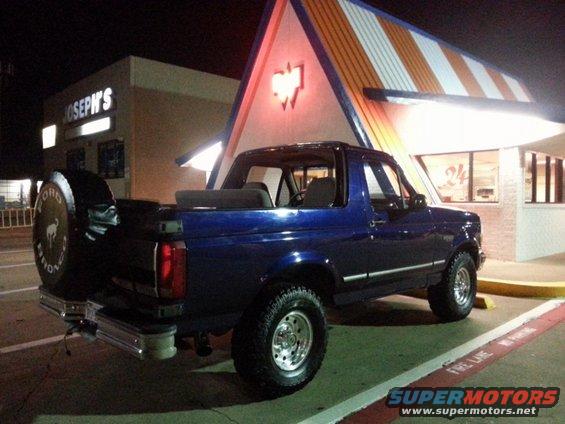 Blue 1995 Ford Bronco parked at night