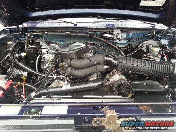 Engine bay of a 1995 Ford Bronco with V8 engine and air intake