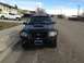 2005 Ford Sport Trac - A black 2005 Ford Sport Trac is parked on a residential street, facing the camera.