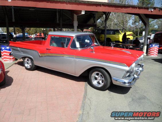Red and silver 1957 Ford Ranchero pickup truck, front 3/4 view, chrome wheels, custom paint