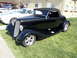 1973 Ford Ranchero - Black 1933 Ford hot rod convertible with a black top is parked on grass at an outdoor event.