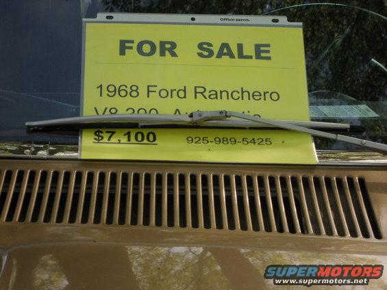 Tan 1968 Ford Ranchero with a "FOR SALE" sign on the windshield, showing the grille and hood