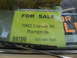 1973 Ford Ranchero - A bright yellow sign in a car window advertises a 1962 Corvair 95 Rampside for $9700.