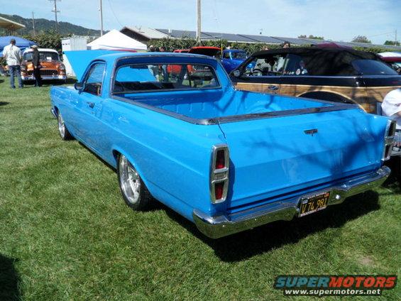 Blue 1973 Ford Ranchero parked on grass, rear view. License plate V74 981