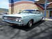 1973 Ford Ranchero - A light blue 1970 Ford Torino GT is viewed from the front-three-quarter angle in front of a building with a colorful facade.
