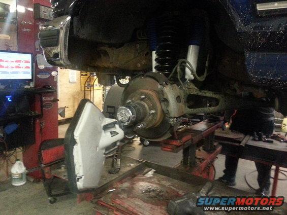 1995 Ford Bronco front suspension and brake assembly on lift