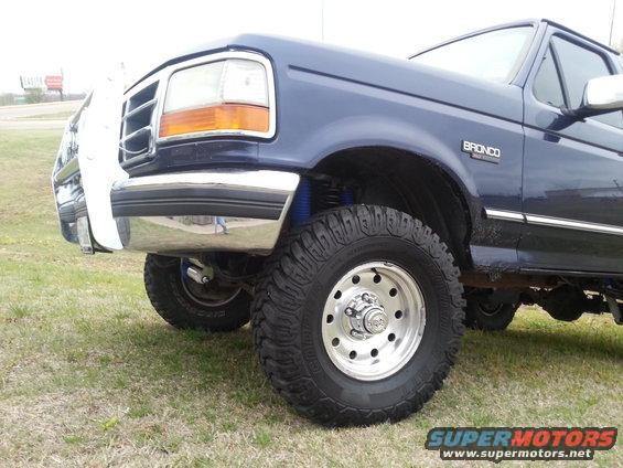 1995 Ford Bronco front fender, chrome bumper, and wheel with off-road tire