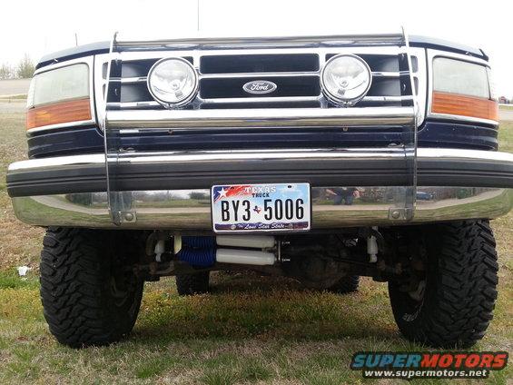 Blue Ford Bronco front view with chrome grille guard, dual headlights, and Texas license plate BY3-5006