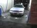 2003 Ford Crown Victoria - A silver 2003 Ford Crown Victoria is parked in a car wash bay, with suds on the floor.