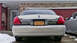 2008 Mercury Grand Marquis - The rear of a Mercury Grand Marquis is shown with a New York license plate and a garage in the background.