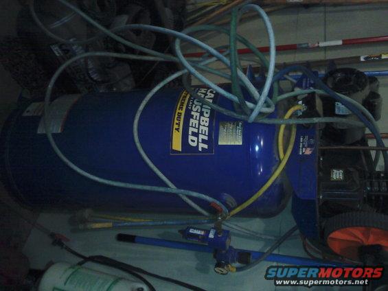 Campbell Hausfeld air compressor with blue tank and hoses