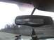 2003 Ford Crown Victoria - Multiple vehicles are seen on the highway through the rearview mirror, with an air freshener hanging from it.
