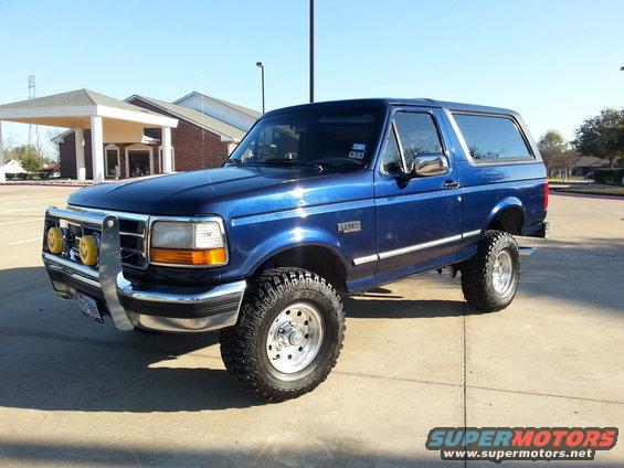 Blue 1995 Ford Bronco with brush guard and lifted suspension