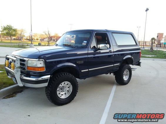 Dark blue 1995 Ford Bronco with lifted suspension and off-road tires