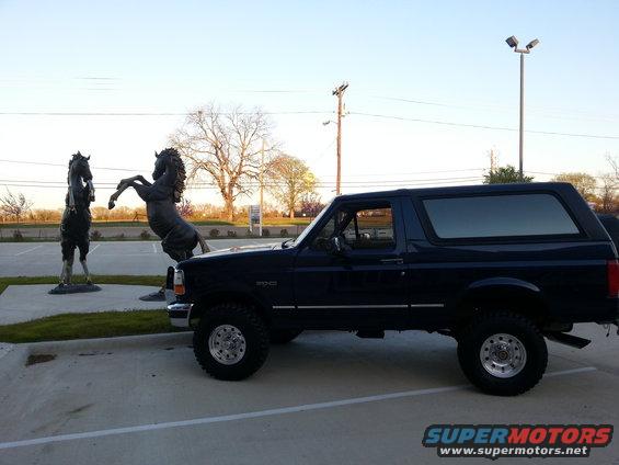 1995 Ford Bronco parked outside with horse sculptures