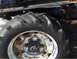 2000 Chevrolet Tahoe - A close-up of a tractor's tire and wheel assembly, showing wear and rust.