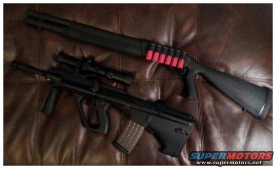 Two black firearms, a shotgun with red shells and a rifle with a scope, lie on a brown leather surface