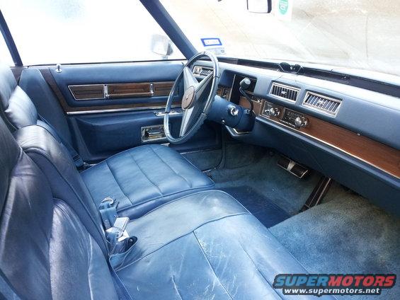 Blue leather interior of a 1970s Cadillac Eldorado, showing front seats, dashboard, and steering wheel