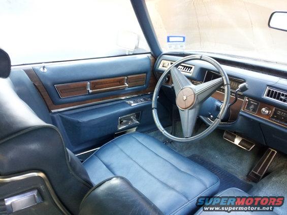 Blue interior with wood trim and a star-shaped steering wheel