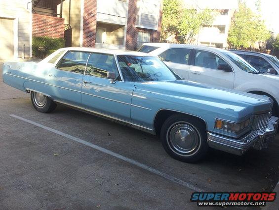 Light blue sedan parked next to a white SUV