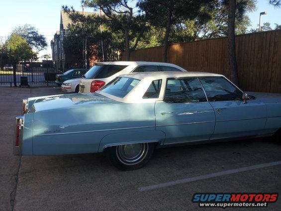 Light blue sedan with white vinyl roof, side view
